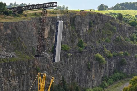 The railway carriage is dropped into the quarry