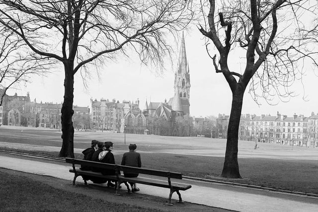 Girls from James Gillespie's High School sitting on bench overlooking Barclay Church at Bruntsfield Links in January 1957.