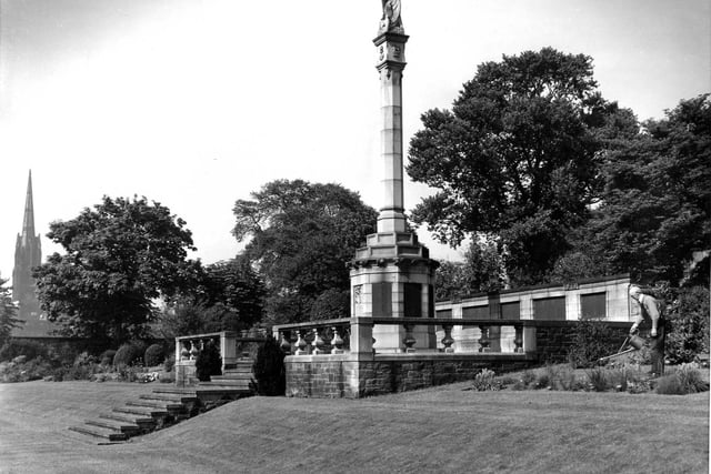 The head gardener tending flowers bordering the George Heriot's School War Memorial, subscribed to by former pupils and relatives of the dead of the two Great Wars, in July 1959.
