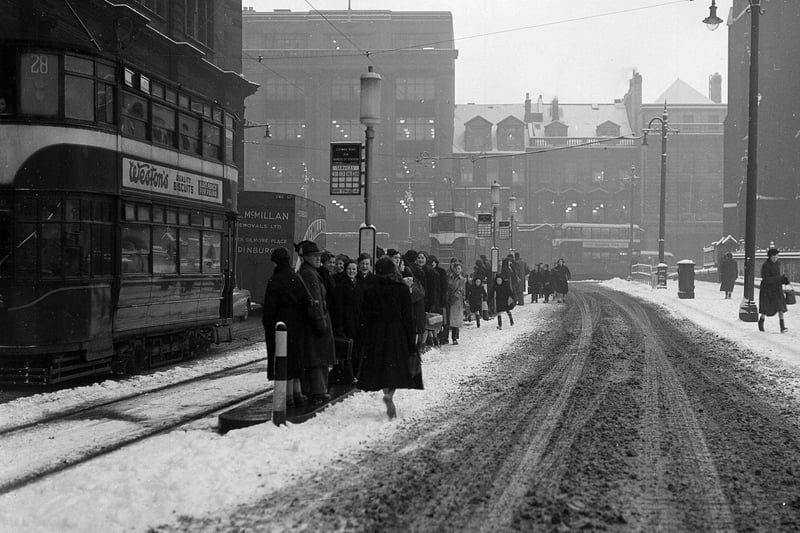 Snow and slush at a tram stop in Edinburgh - looking north down Lothian Road to the West End in February 1955.