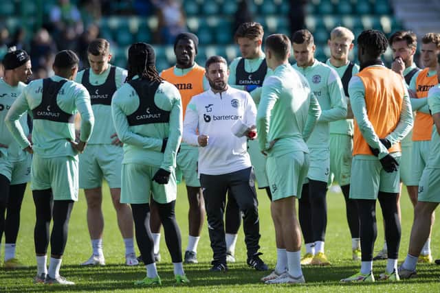 Lee Johnson speaks to the Hibs players during an open training session at Easter Road
