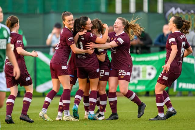 Erin Rennie is mobbed by her teammates after scoring the opener against Hibs. Credit: Malcolm Mackenzie