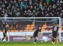 Kevin Nisbet celebrates in front of the jubilant Hibs support after putting the club 1-0 up in Sunday's win over Motherwell. Picture: SNS