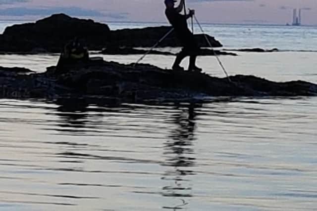 Barry McEwan fishing off rocks at Dunbar during a Bass Rock Shore Angling League match