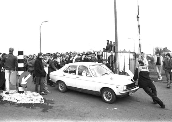One of the pickets tries to stop a fellow miner's car coming through Bilston Glen colliery gates during the industrial action of March 1984.