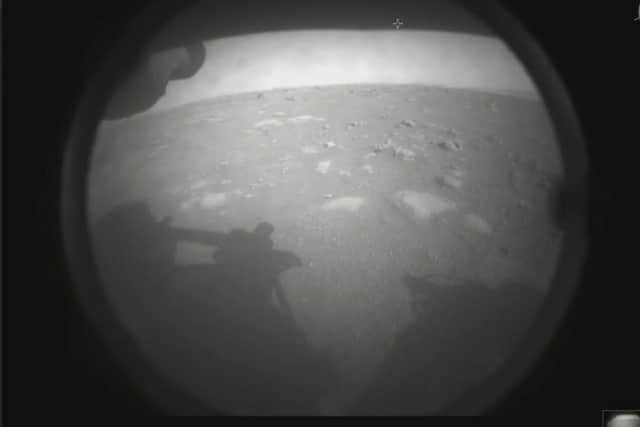 The camera on the rover, covered in dust from the landing, took a snap of the surface.