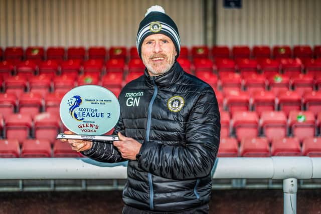 Gary Naysmith shows off his Glen's Manager of the Month award at Ainslie Park