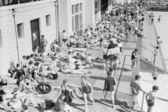 Crowds sunbathing poolside at Portobello Outdoor Swimming Pool in 1955.