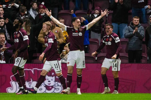 Aaron McEneff celebrates after scoring Hearts' fifth goal against Dundee United.