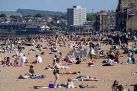 People on Portobello Beach in Edinburgh on Tuesday, enjoying the warm weather on what is believed to be the hottest day so far this year in Scotland.