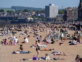 People on Portobello Beach in Edinburgh on Tuesday, enjoying the warm weather on what is believed to be the hottest day so far this year in Scotland.