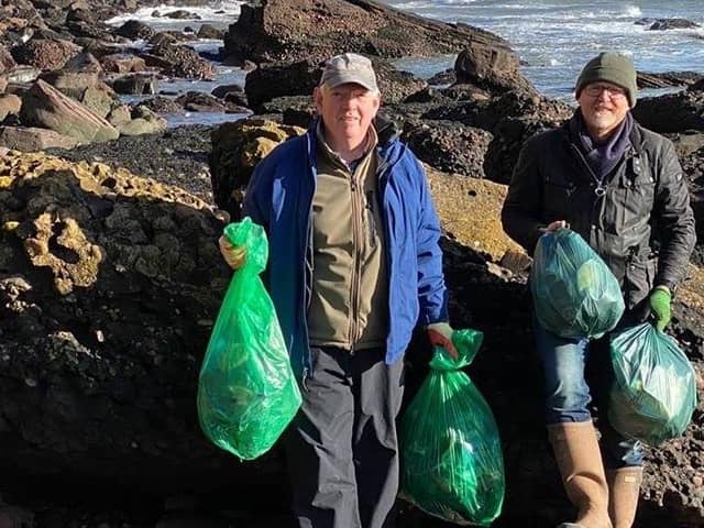 Two of Select Scotland Guides on one of the many beach cleans around Scotland.