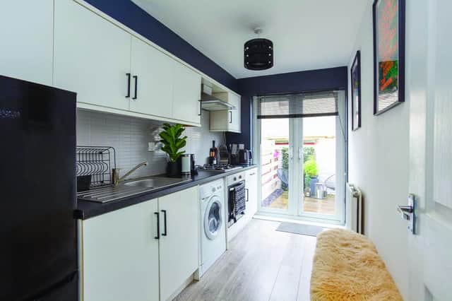 Compact galley kitchen leads out to the garden