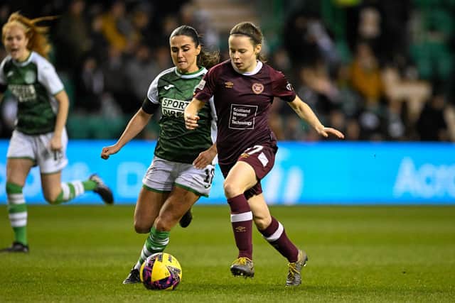 Hearts' Cailin Michie runs past Hibs' Shannon McGregor during the SWPL1 match between the Edinburgh rivals at Easter Road on Sunday. Picture: Malcolm Mackenzie
