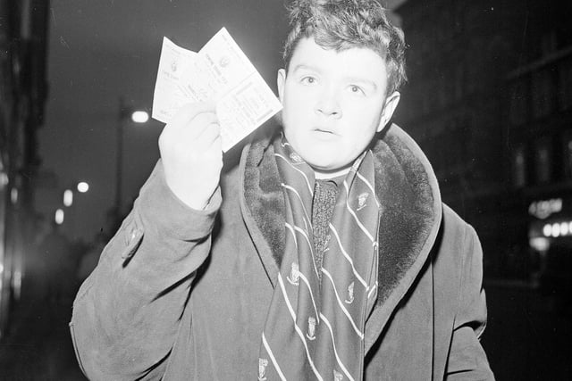 Wearing his official Hearts Supporter scarf, Alex Spence shows off his sought-after two tickets for the Hearts v Hibs Edinburgh Derby at Tynecastle on New Year's Day 1965.