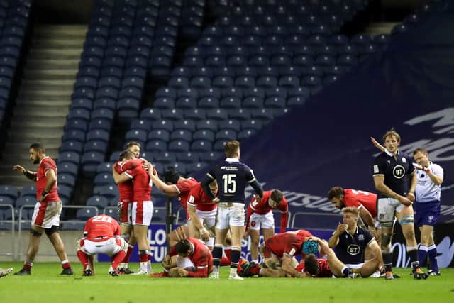 Wales celebrate at full-time but it's agony for Scotland. Picture: Jane Barlow/PA