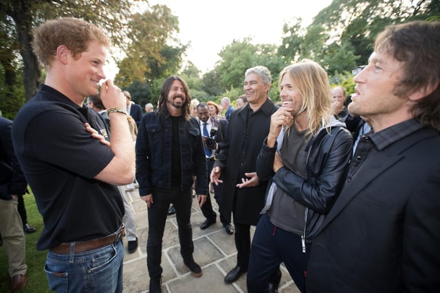 Duke of Sussex (then known as Prince Harry) talking to the Foo Fighters at the Invictus Games welcome reception in Regents Park, London.
