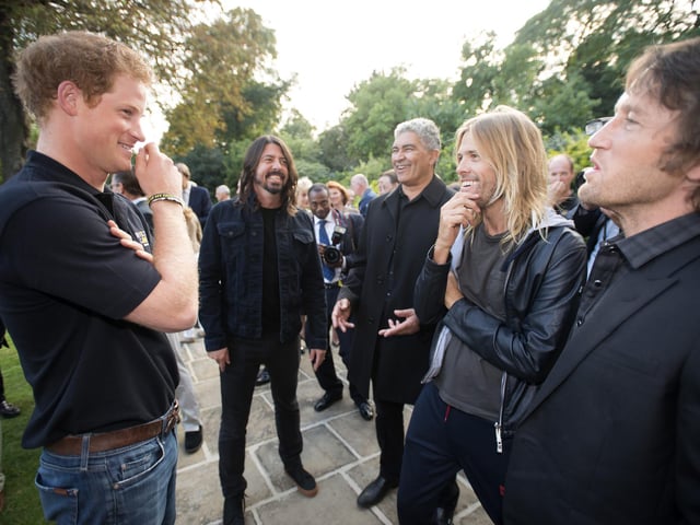 Duke of Sussex (then known as Prince Harry) talking to the Foo Fighters at the Invictus Games welcome reception in Regents Park, London.