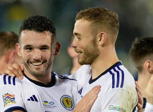Ryan Porteous and John McGinn embrace at full-time after Scotland's 0-0 draw with Ukraine in Krakow. Picture: Craig Williamson / SNS