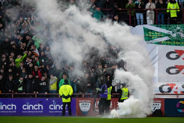 A smoke bmb is thrown onto the pitch during a cinch Premiership match between Heart of Midlothian and Hibernian at Tynecastle, on January 02, 2023, in Edinburgh, Scotland. (Photo by Mark Scates / SNS Group)