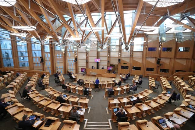 MSPs finally moved to the new parliament building at Holyrood in 2004     Pic: PA