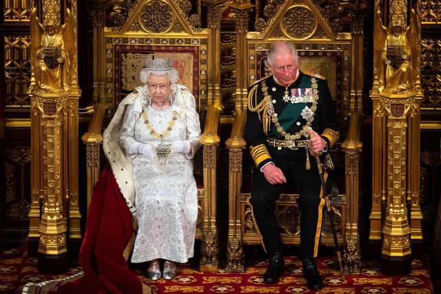 Queen Elizabeth II sits with Prince Charles on the Sovereign's throne to deliver the Queen's Speech at the State Opening of Parliament in the Houses of Parliament in London in 2021. Photo: VICTORIA JONES/POOL/AFP via Getty Images.