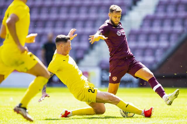 Bonnyrigg Rose's Callum Connolly tackles Hearts midfielder Jorge Grant during the friendly at Tynescastle
