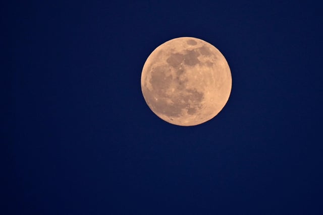 The full moon is pictured on May 15, 2022 from Cagliari, Sardinia (Photo by ALBERTO PIZZOLI/AFP via Getty Images)