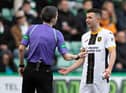 Livingston's Jason Holt is shown a red card by referee Craig Napier after playing the ball but catching Kevin Nisbet with a high boot in the aftermath. Picture: Paul Devlin / SNS