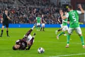 Hearts' Kenneth Vargas goes down in the box after a challenge from Hibs' Will Fish.