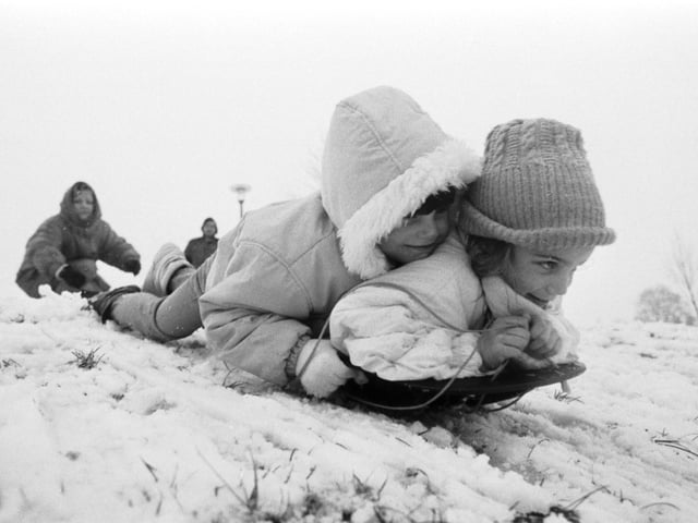 Two little girls sledging at Bruntsfield Links in February 1989.