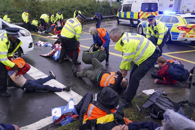 Police break up an Insulate Britain protest at a roundabout leading from the M25 motorway to Heathrow Airport in London (Picture: Steve Parson/PA)