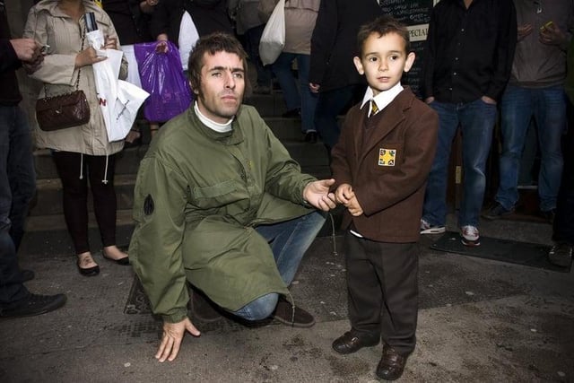 Oasis lead singer Liam Gallagher meets a young fan outside The Halfway House pub on Fleshmarket Close in Edinburgh. Photo: Ian Georgeson
