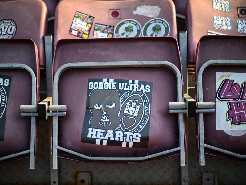 Seating with stickers is pictured before the start of the match (Photo by ANDY BUCHANAN / AFP via Getty Images)