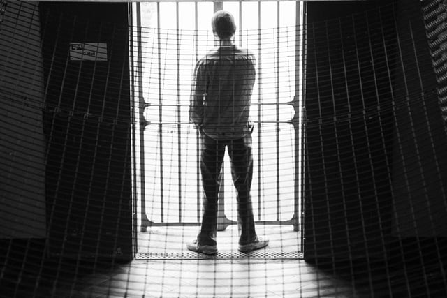 A prisoner looking through the bars of C Hall, Saughton Jail, Edinburgh, in June, 1994.