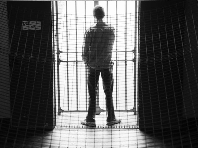 A prisoner looking through the bars of C Hall, Saughton Jail, Edinburgh, in June, 1994.