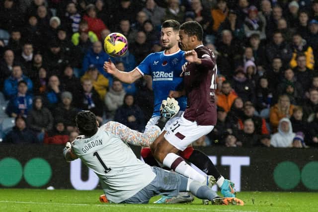 Craig Gordon saves from Rangers striker Antonio Colak with Hearts defender Toby Sibbick applying the pressure. Picture: SNS