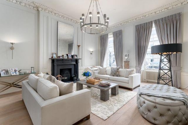 There is a wonderful living room found on the ground level, which benefits from an abundance of natural light thanks to the large windows, and a delightful marble fireplace