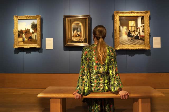 A member of staff looking at Dutch Golden Age paintings by Pieter de Hooch and Jan Steen, which will be displayed in the 'Masterpieces from Buckingham Palace' exhibition in The Queen's Gallery at the Palace of Holyroodhouse in Edinburgh.