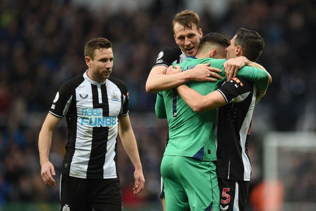 Newcastle United's Welsh defender Paul Dummett (L), Newcastle United's English defender Dan Burn (2nd L), Newcastle United's Slovakian goalkeeper Martin Dubravka (2nd R) and Newcastle United's Swiss defender Fabian Schar (R) celebrate on the pitch after the English Premier League football match between Newcastle United and Aston Villa at St James' Park in Newcastle-upon-Tyne, north east England on February 13, 2022. (Photo by OLI SCARFF/AFP via Getty Images)