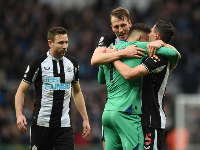 Newcastle United's Welsh defender Paul Dummett (L), Newcastle United's English defender Dan Burn (2nd L), Newcastle United's Slovakian goalkeeper Martin Dubravka (2nd R) and Newcastle United's Swiss defender Fabian Schar (R) celebrate on the pitch after the English Premier League football match between Newcastle United and Aston Villa at St James' Park in Newcastle-upon-Tyne, north east England on February 13, 2022. (Photo by OLI SCARFF/AFP via Getty Images)