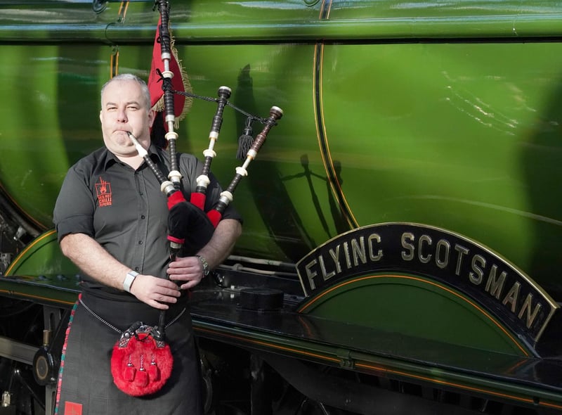 Kevin MacDonald, from the Red Hot Chilli Pipers, provides some music to mark the occasion.