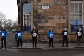 Members and officials from Leith Victoria held up placards with a message reading "RIP Joe".