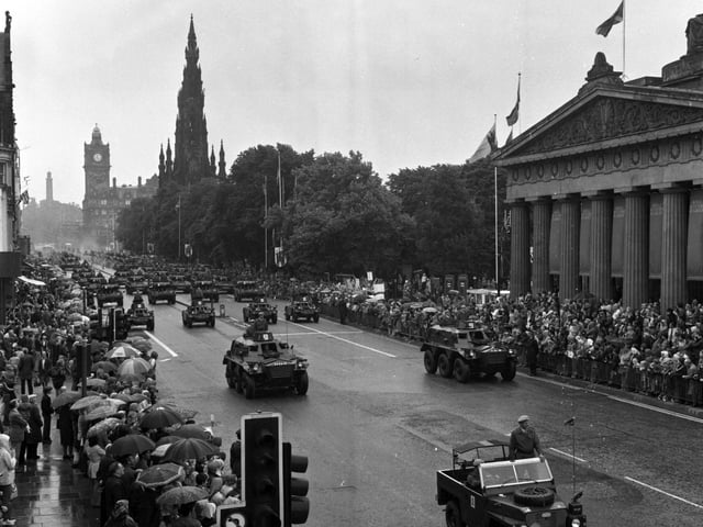 Crowds ignore the rain to enjoy the procession of tanks and armoured vehicles in Princes Street, marking the centenary of the Royal Scots Dragoon Guards in July 1978.