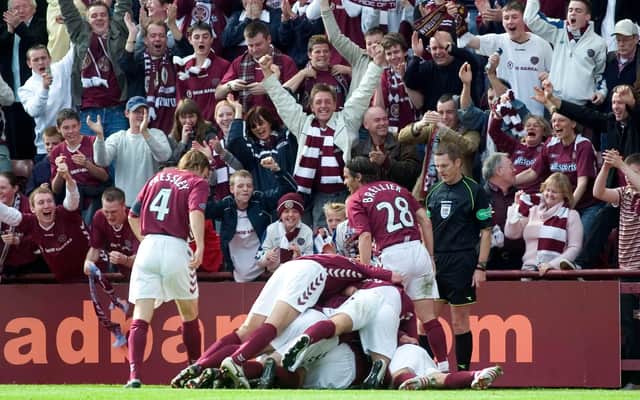 Hearts players pile on top of goalscorer Roman Bednar in front of jubilant fans at Tynecastle. Picture: SNS