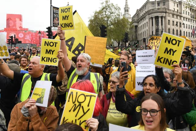 Protesters hold up placards ahead of the coronation of King Charles III and Queen Camilla in London (Picture: Chris J Ratcliffe/Getty Images)