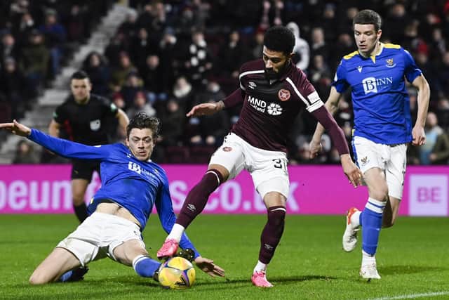 Two-goal hero Josh Ginnelly is challenged by St Johnstone's Murray Davidson in the box but no penalty