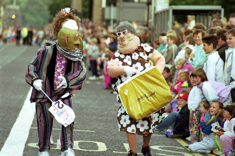 Characters from Big Nazo, an American theatre and performance group, taking part in the Evening News Edinburgh Festival Fringe Cavalcade along Princes Street in August 1991.