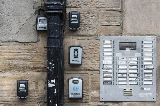Airbnb locks affixed to the wall of an Edinburgh tenement