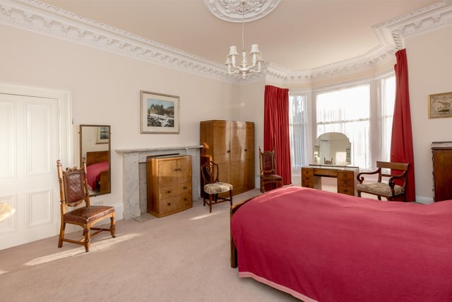 The property's main bedroom is incredibly spacious, with plenty of room for a large bed and furniture.